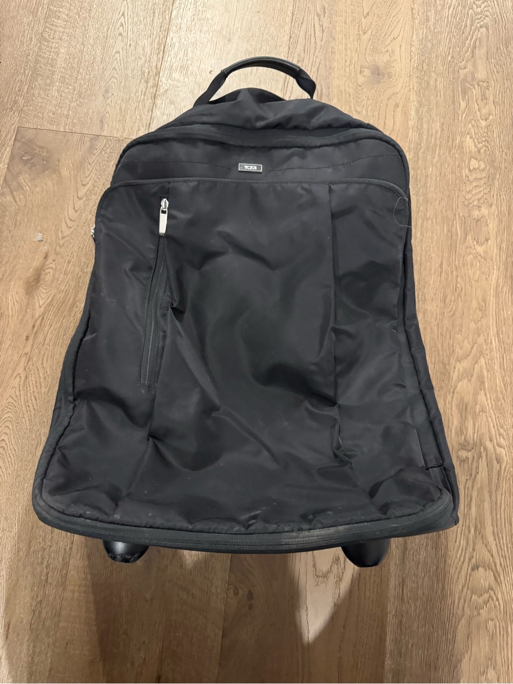 Tumi Black Rolling Bag with Front Zip Pocket and Top Handle